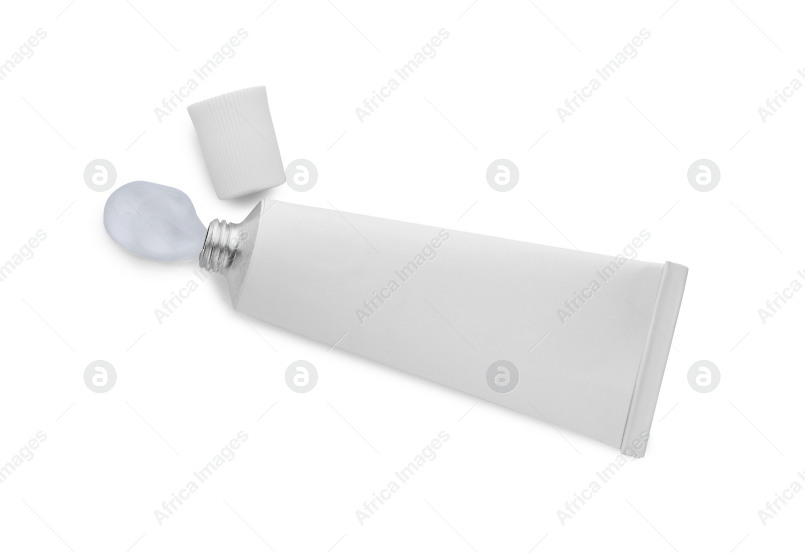 Photo of Open tube with ointment on white background, top view