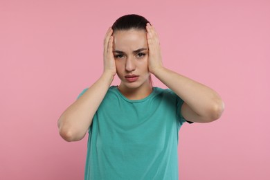 Resentment. Portrait of upset woman on pink background