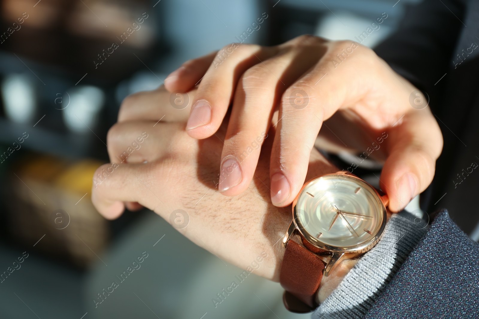 Photo of Man with luxury wrist watch on blurred background, closeup