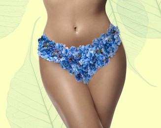 Image of Epilation concept. Young woman with flowers as panties on pale yellow background, closeup