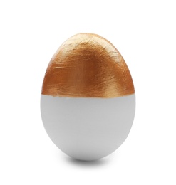 Photo of Traditional Easter egg decorated with golden paint on white background