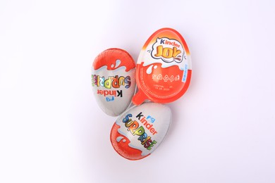 Photo of Slynchev Bryag, Bulgaria - May 24, 2023: Kinder Surprise and Joy Eggs on white background, top view