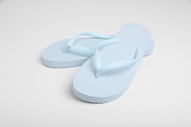 Pair of stylish flip flops on white background