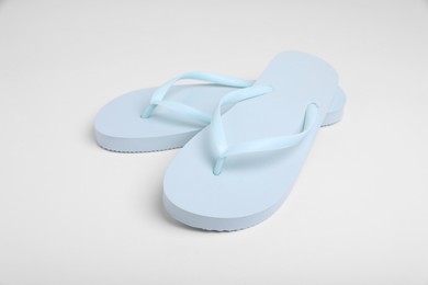 Photo of Pair of stylish flip flops on white background