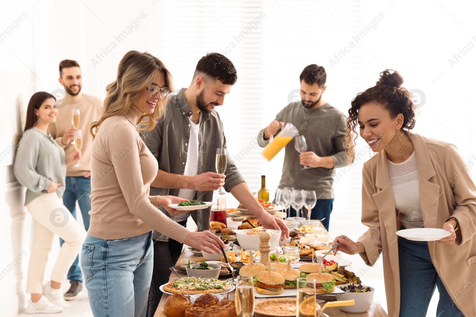 Photo of Group of people enjoying brunch buffet together indoors