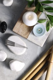 Photo of Flat lay composition with acupuncture needles on light grey marble table