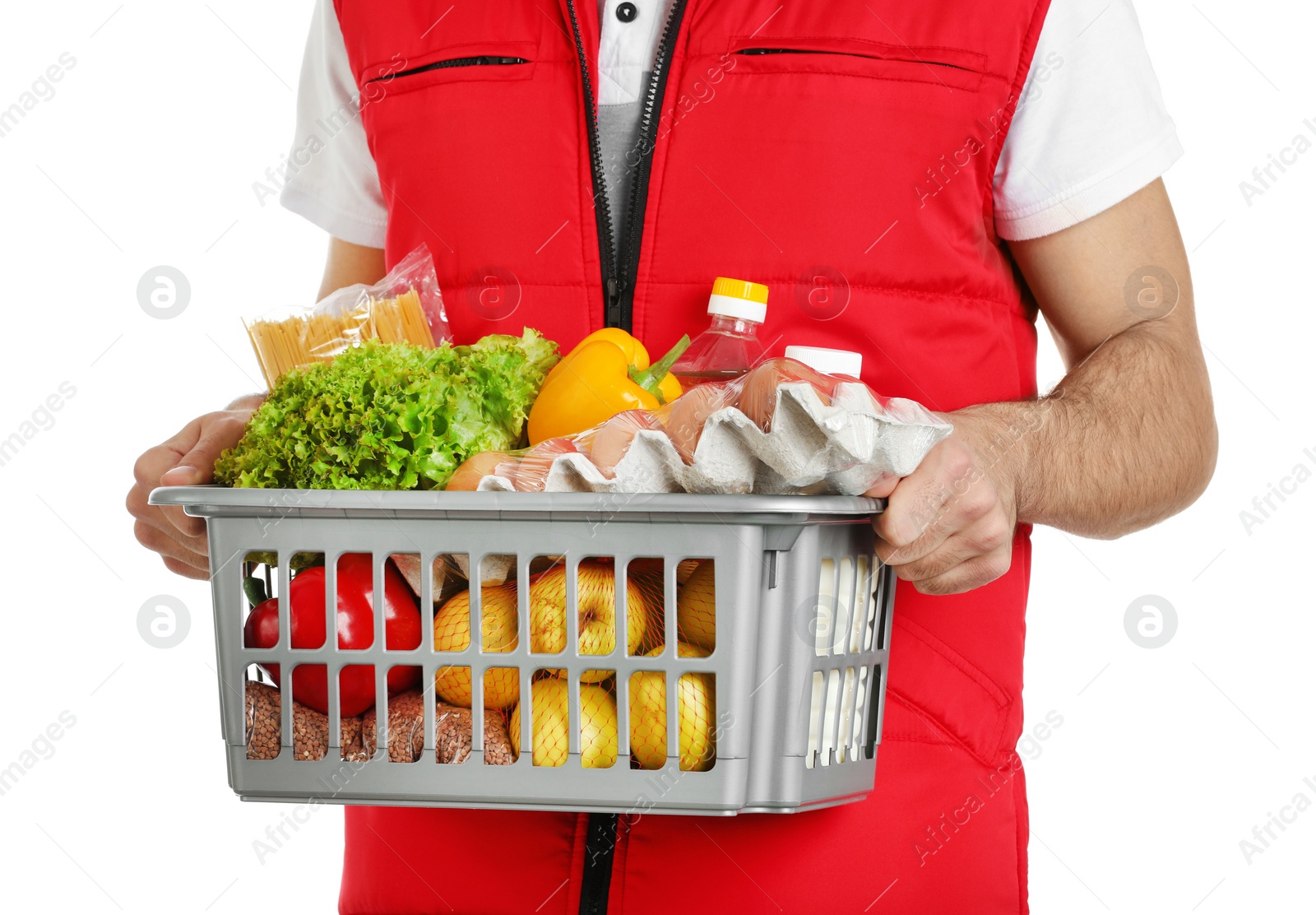 Photo of Man holding basket with fresh products on white background, closeup. Food delivery service