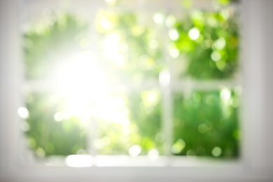 Photo of Blurred view through window on garden in morning