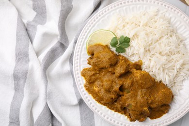 Photo of Delicious chicken curry with rice on table, top view