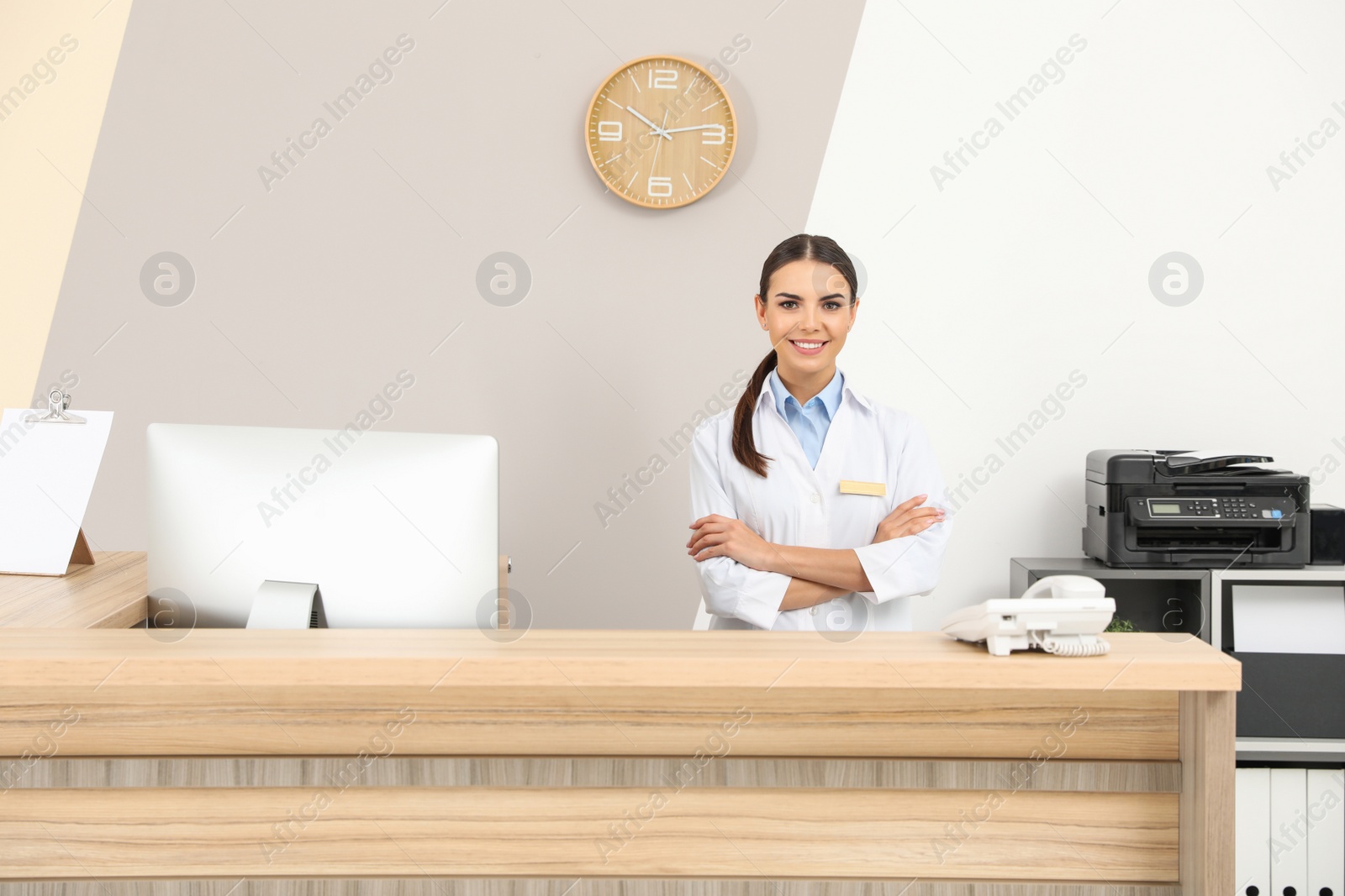 Photo of Portrait of receptionist at desk in modern clinic