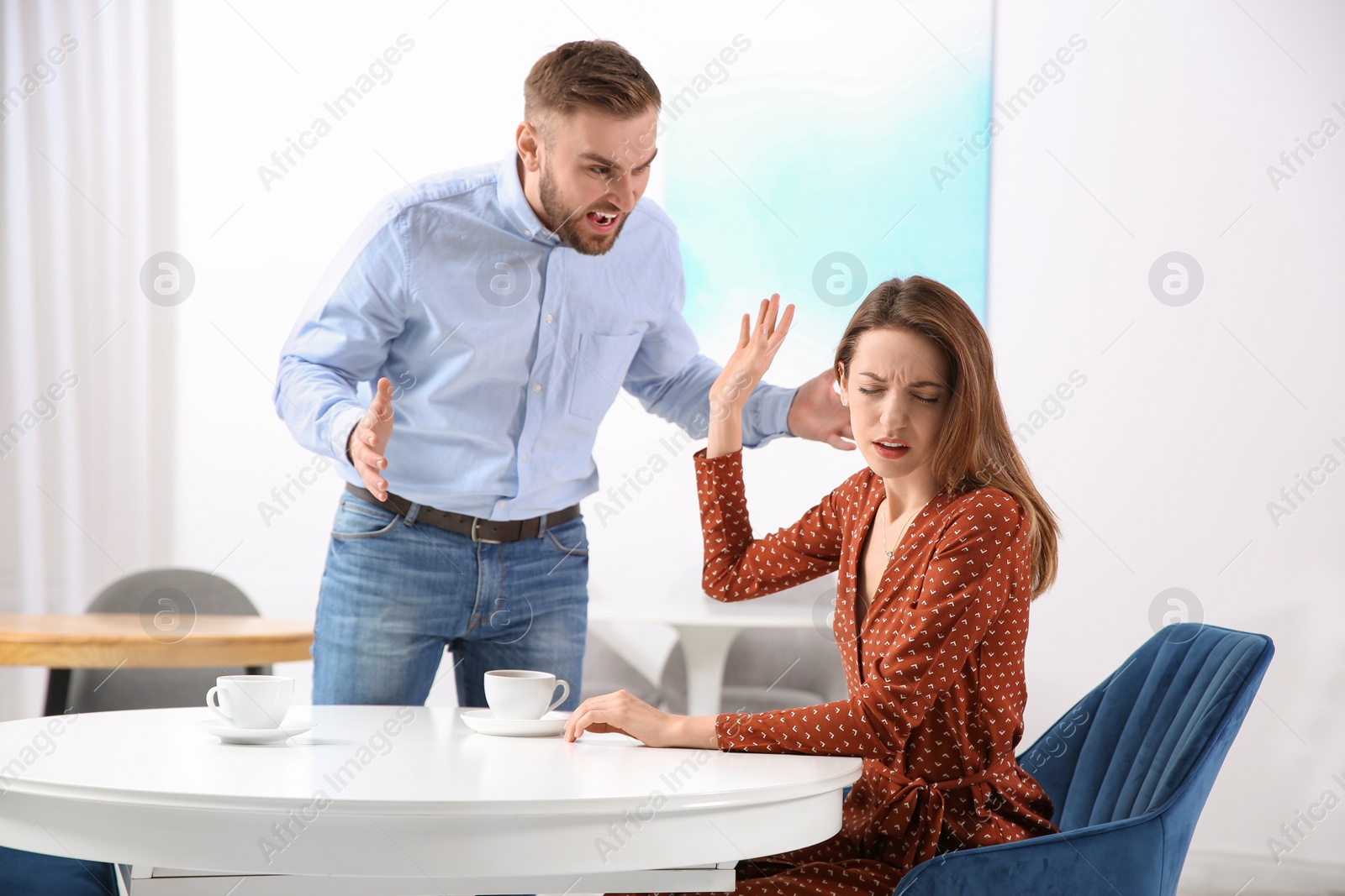 Photo of Couple having quarrel in cafe. Relationship problems