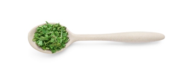 Photo of Spoon of dried parsley isolated on white, top view