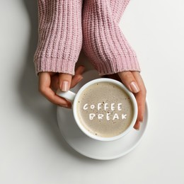 Image of Coffee Break. Woman with cup of americano at white table, top view