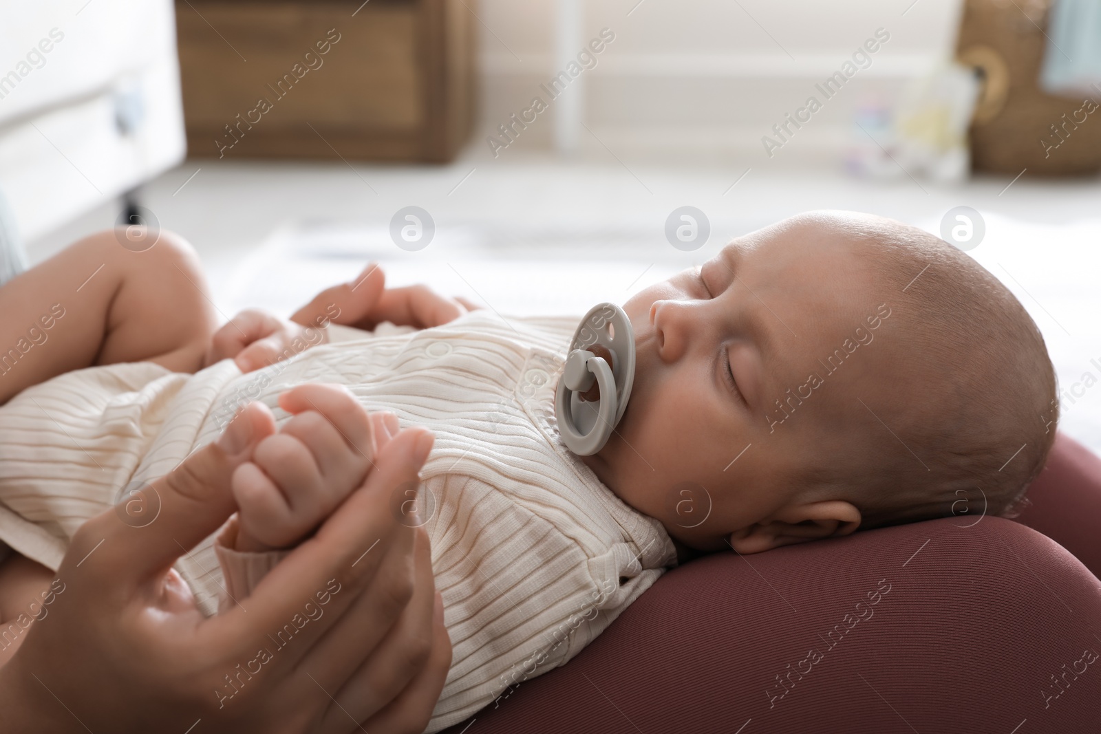 Photo of Mother with her cute sleeping baby at home, closeup