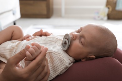 Photo of Mother with her cute sleeping baby at home, closeup