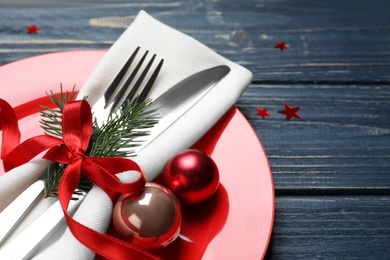 Photo of Christmas table setting on blue wooden background, closeup