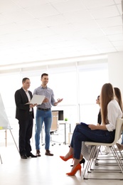 Business trainers giving lecture in office