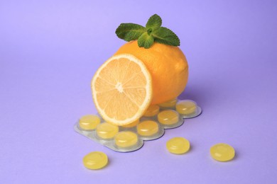 Photo of Fresh lemons, mint leaves and blister with cough drops on lilac background