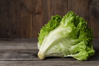 Fresh lettuce on wooden table, space for text