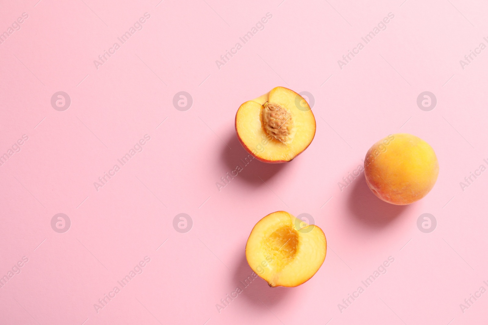 Photo of Flat lay composition with ripe peaches on color background