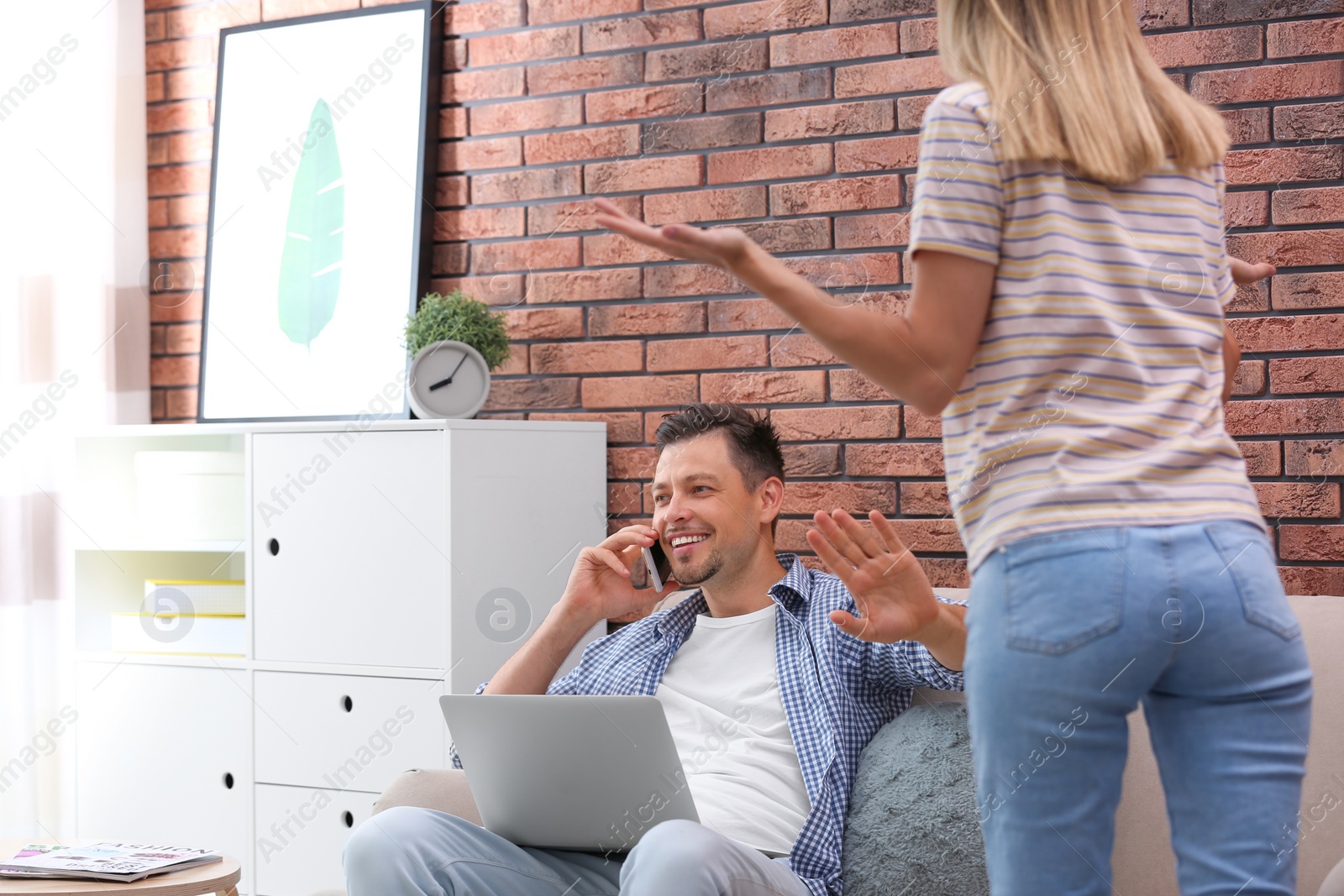 Photo of Lazy husband quarrelling with hardworking wife at home