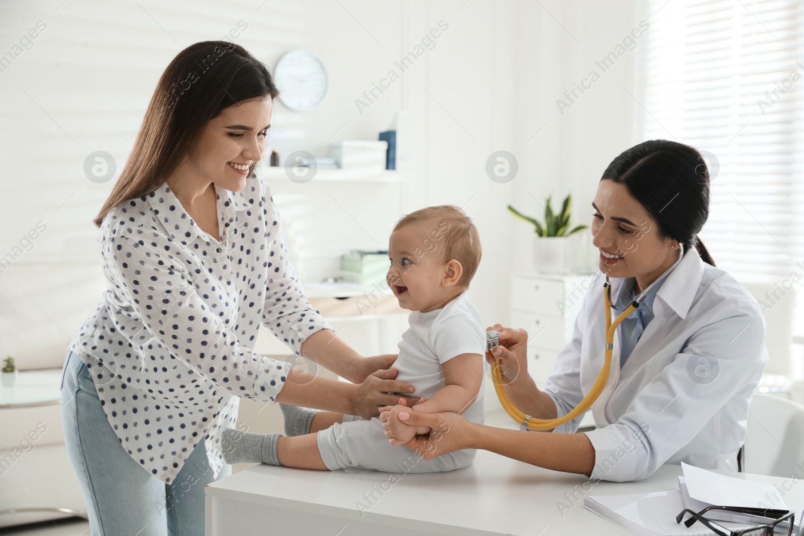 Photo of Mother with her cute baby visiting pediatrician in clinic