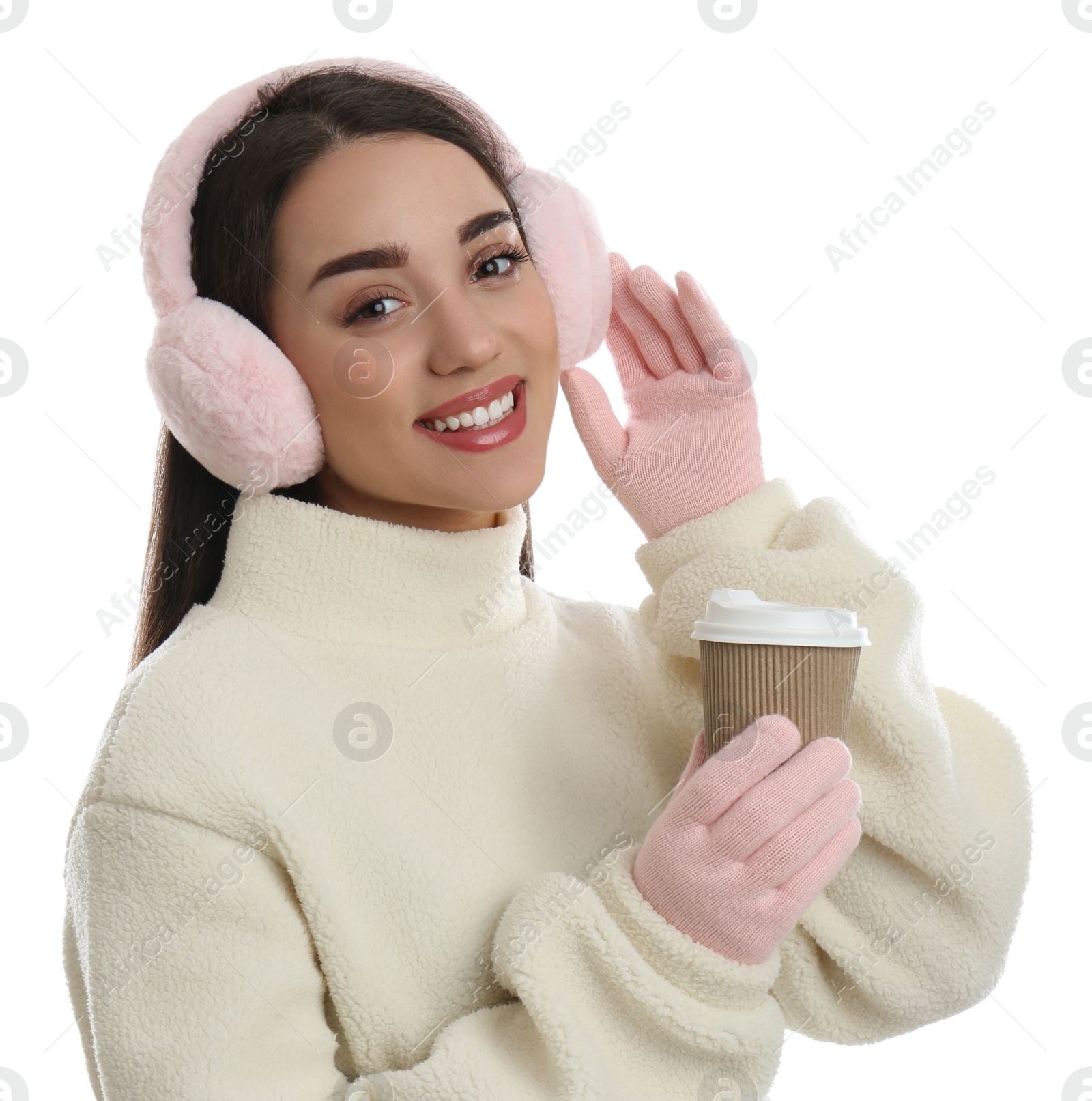 Photo of Beautiful young woman in earmuffs with cup of drink on white background