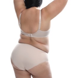 Photo of Back view of overweight woman in beige underwear on white background, closeup. Plus-size model