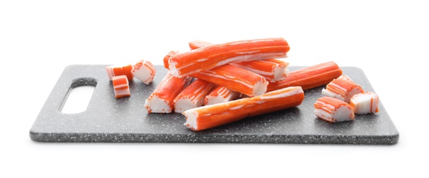 Photo of Black board with delicious crab sticks isolated on white