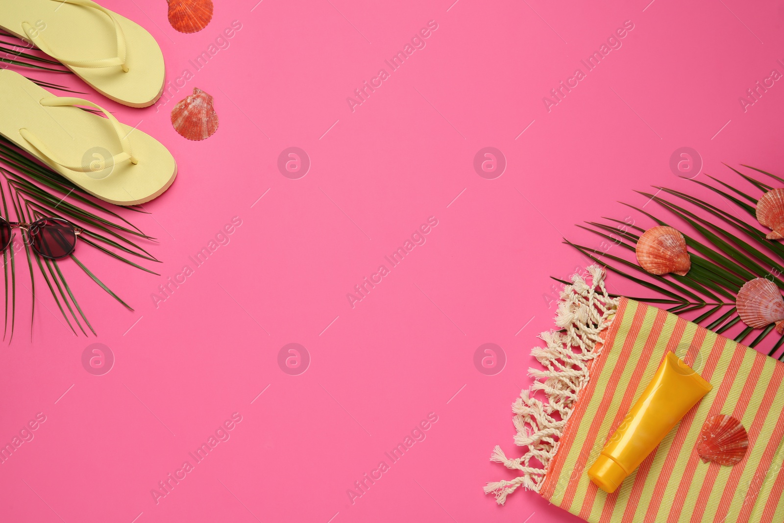 Photo of Flat lay composition with different beach objects on pink background, space for text