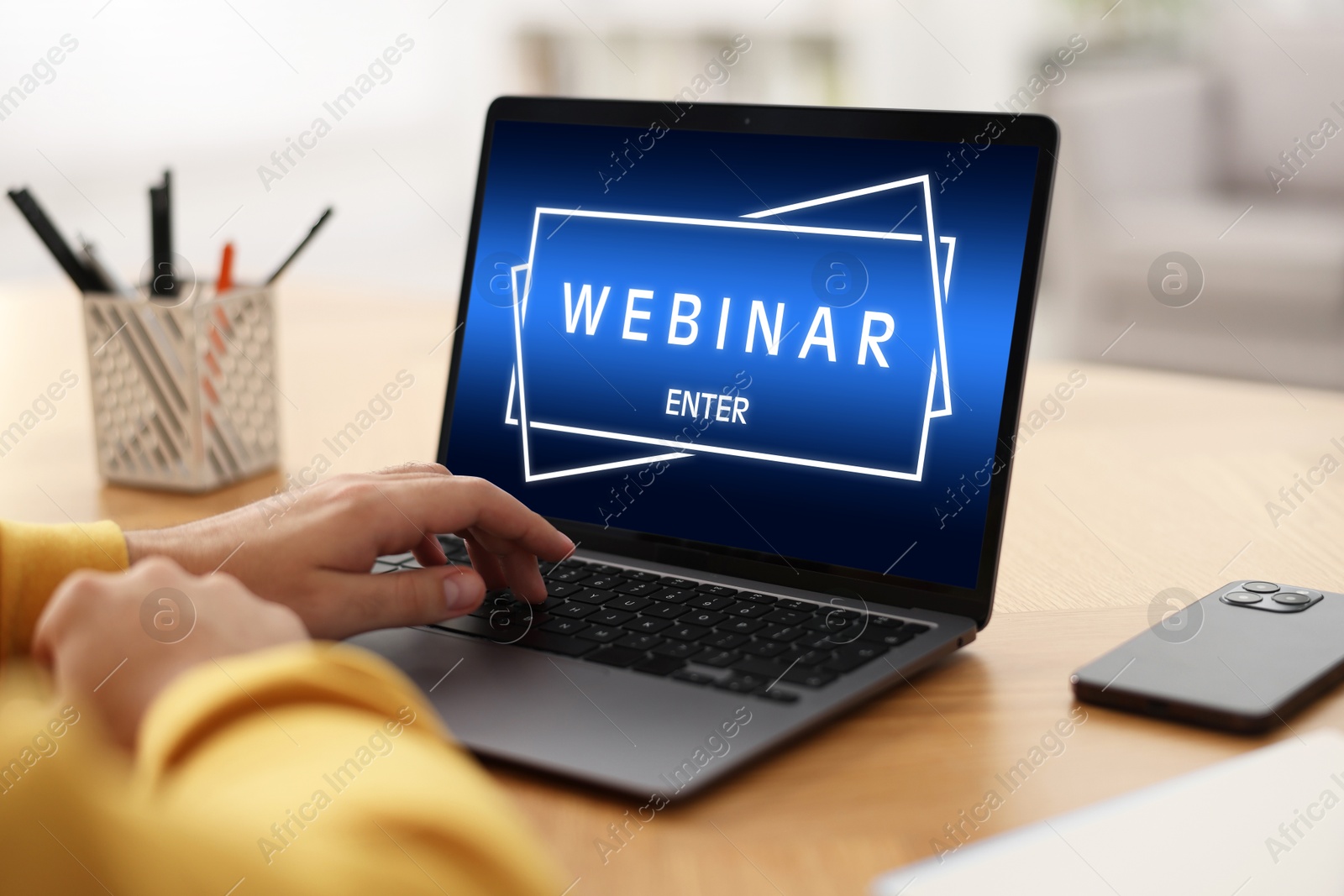 Image of Webinar. Man using laptop at table, closeup