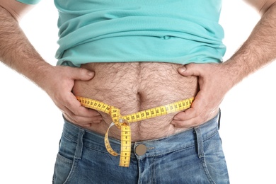 Photo of Overweight man with large belly and measuring tape isolated on white, closeup