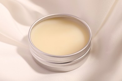 Photo of Lip balm on white fabric, closeup view