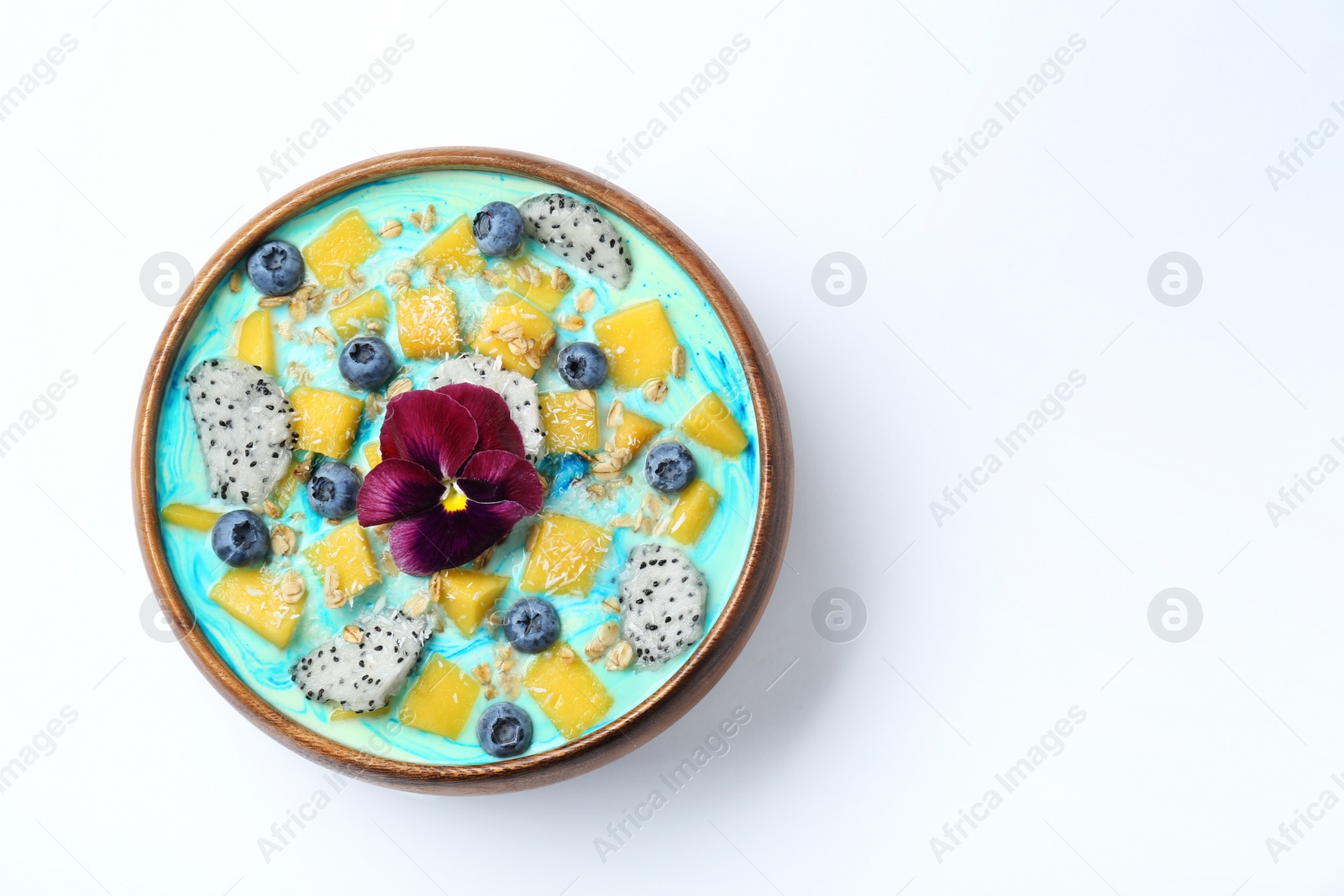 Photo of Delicious smoothie bowl with fresh fruits, blueberries, flower and oatmeal on white background, top view. Space for text