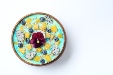 Delicious smoothie bowl with fresh fruits, blueberries, flower and oatmeal on white background, top view. Space for text