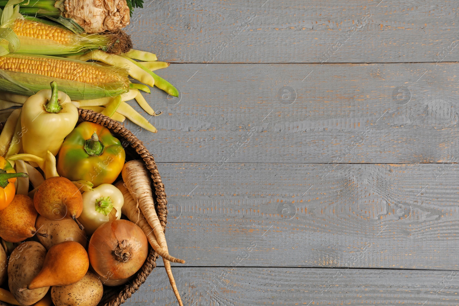 Photo of Different fresh ripe vegetables and fruits on grey wooden table, flat lay. Space for text
