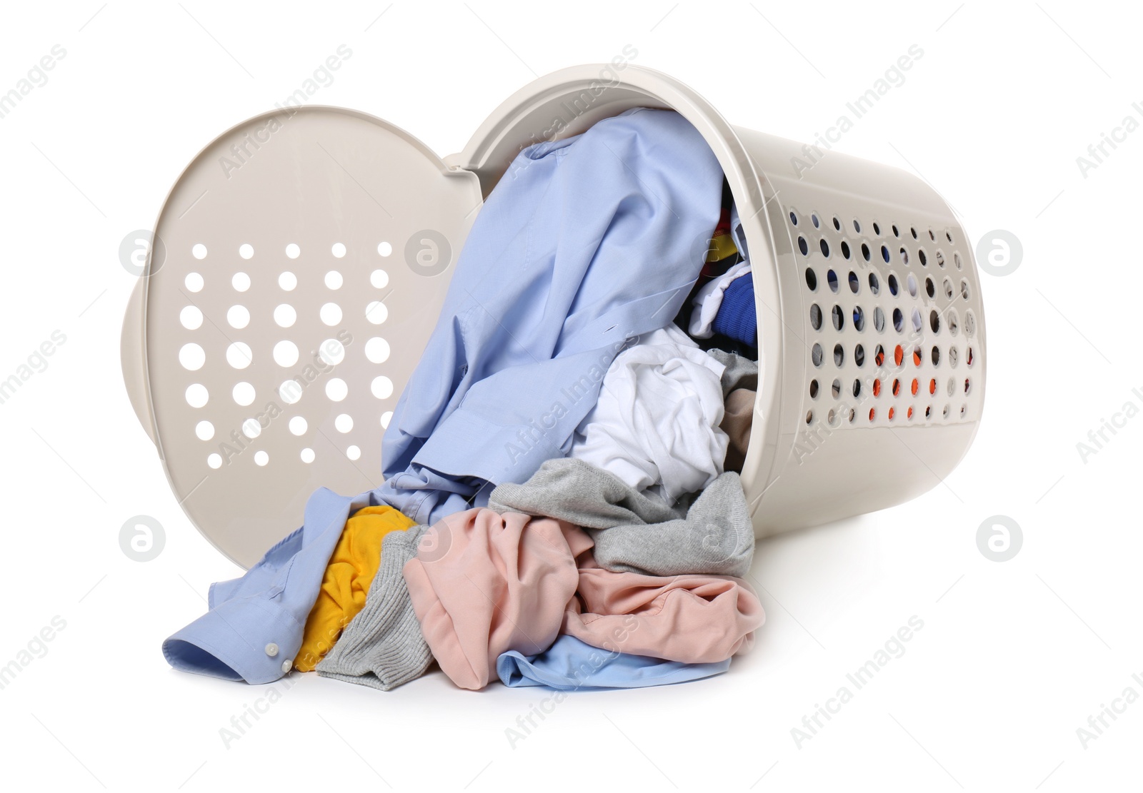 Photo of Overturned laundry basket full of clothes isolated on white