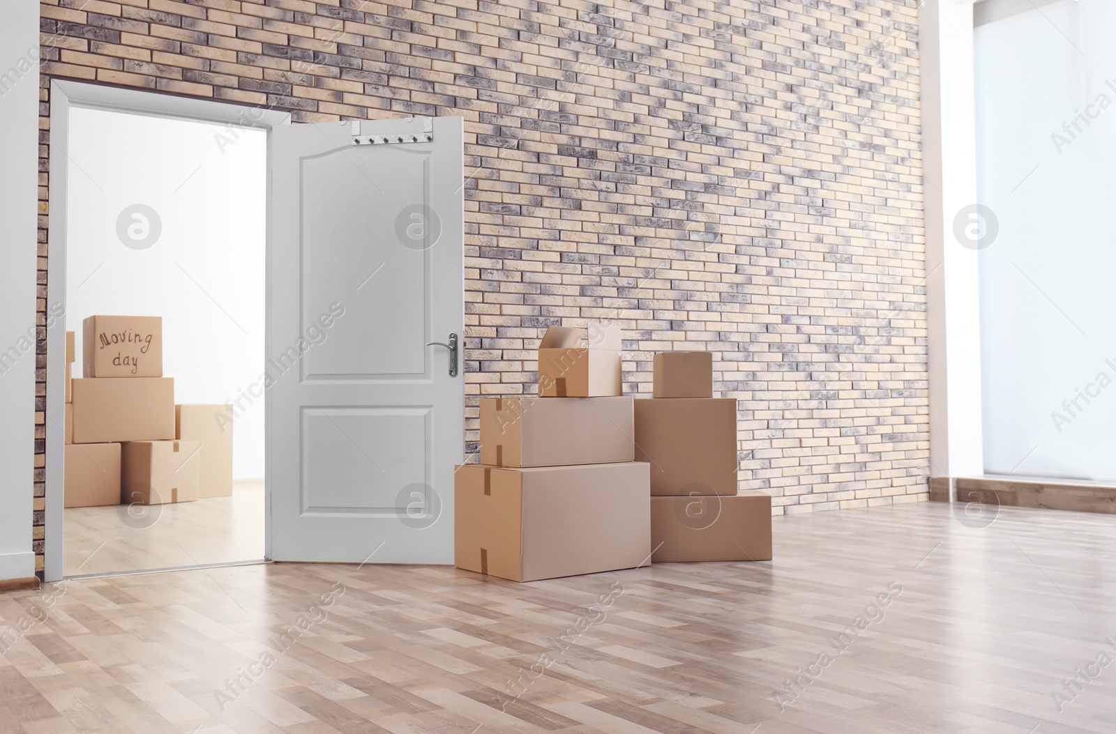 Photo of Pile of moving boxes in empty room