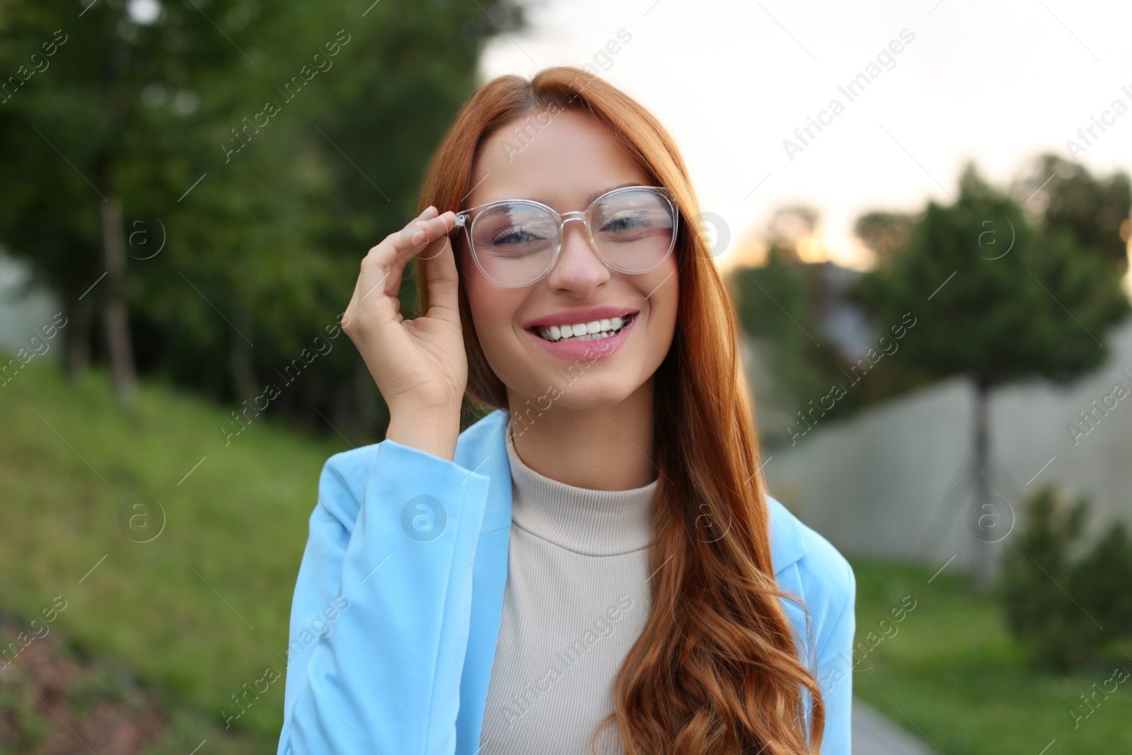 Photo of Portrait of beautiful woman in glasses outdoors