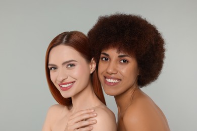 Portrait of beautiful young women on light grey background