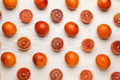 Photo of Many ripe sicilian oranges on white wooden table, flat lay