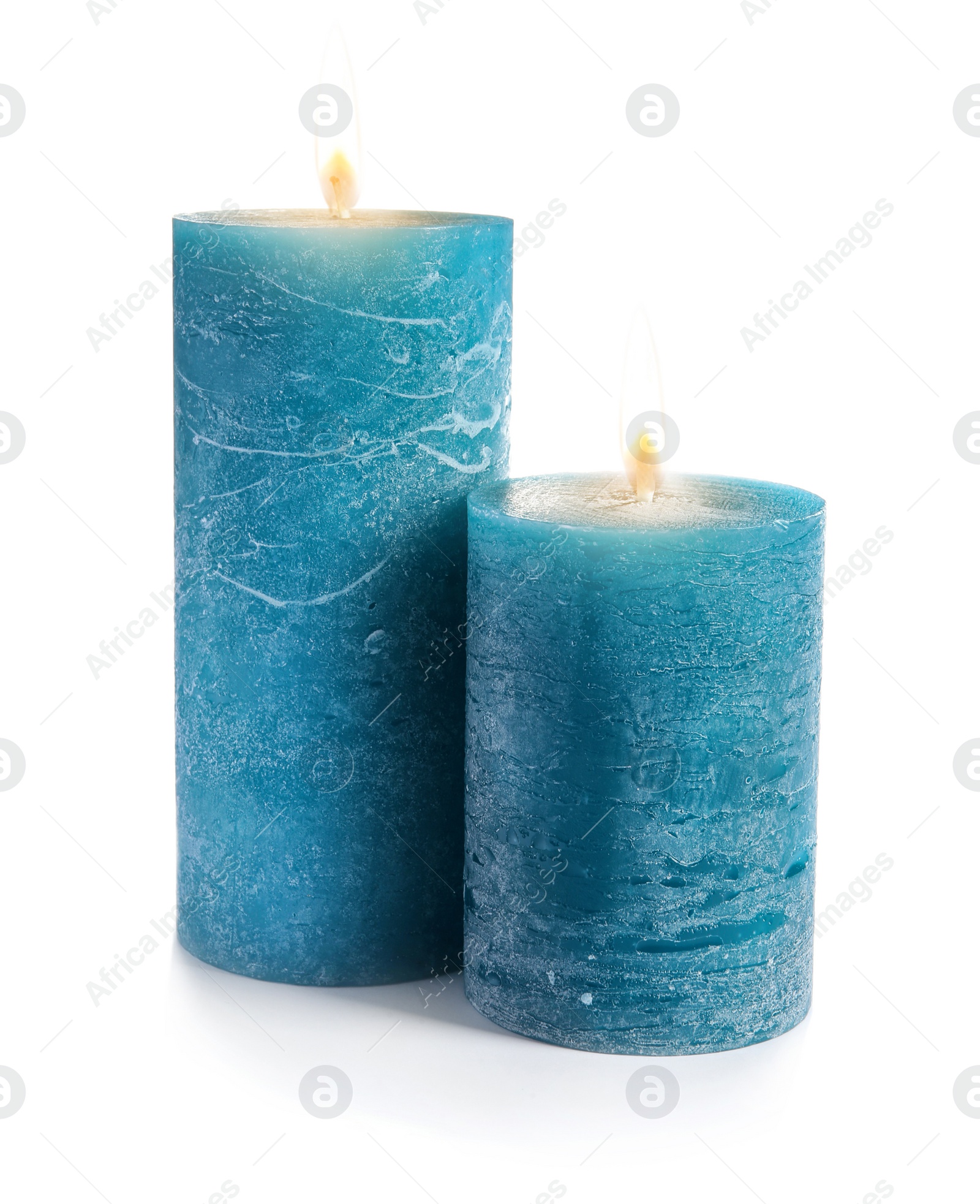 Photo of Two decorative blue wax candles on white background