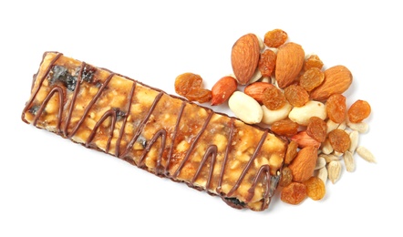 Grain cereal bar with chocolate, nuts and raisins on white background