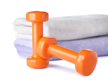 Photo of Stylish dumbbells and towels on white background. Home fitness