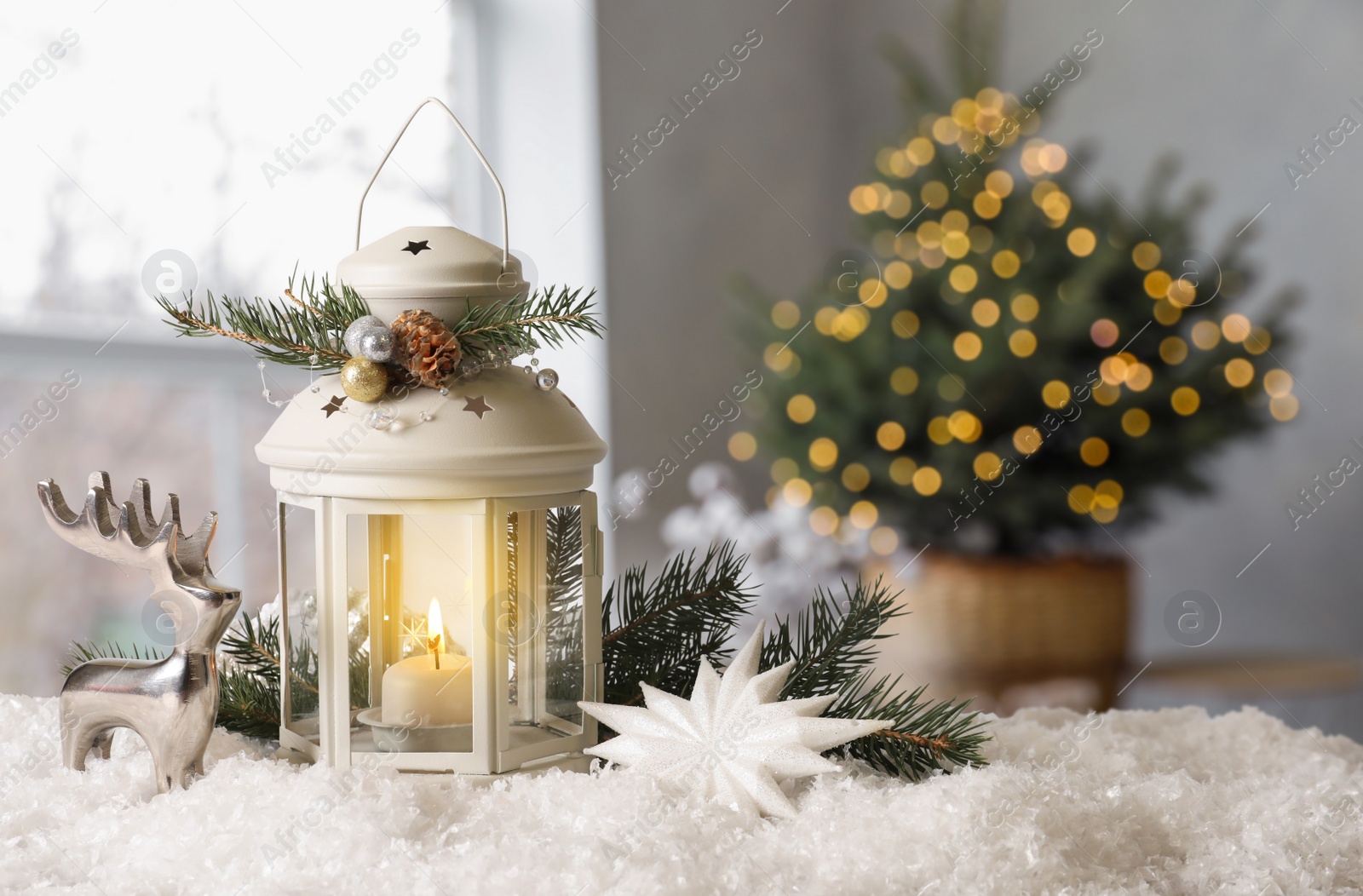 Image of Composition with Christmas lantern on table in decorated room, space for text