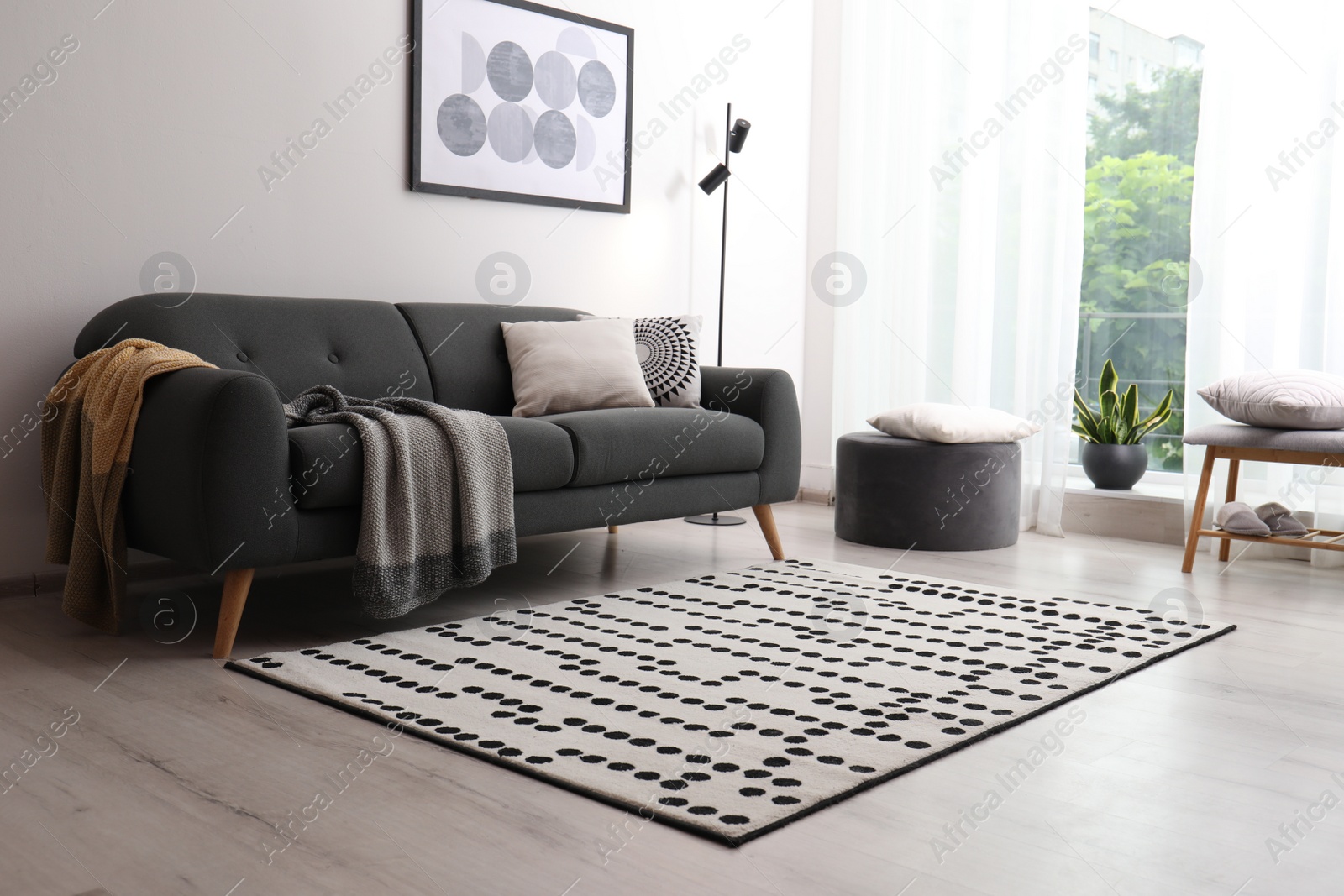 Photo of Living room interior with comfortable sofa and stylish rug