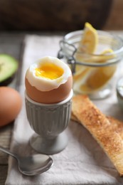 Photo of Soft boiled egg served for breakfast on wooden table