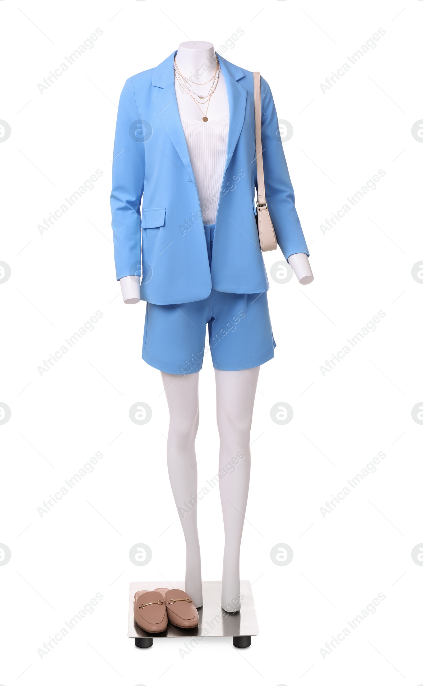 Photo of Female mannequin dressed in light blue suit and top with accessories isolated on white. Stylish outfit