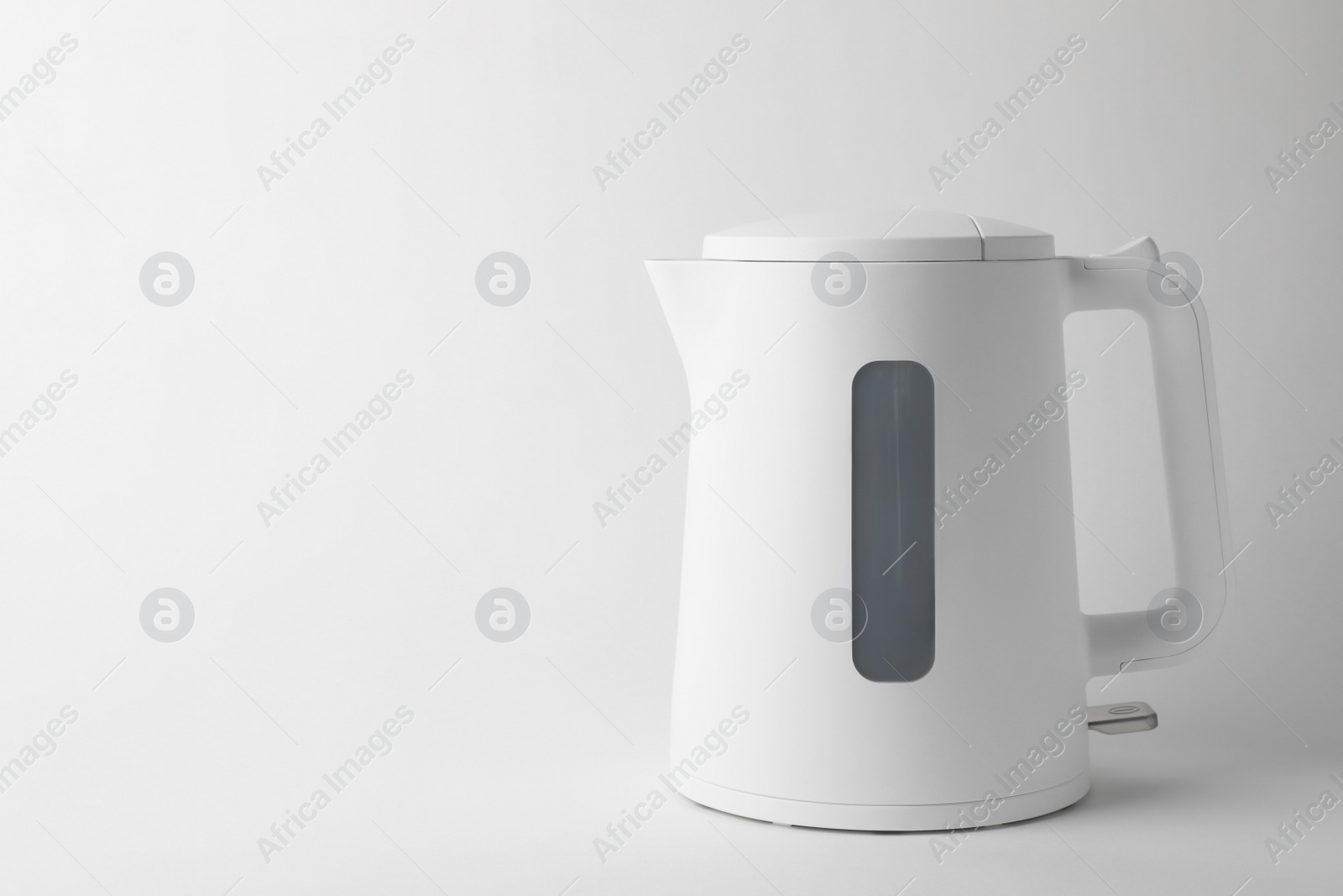 Photo of Modern electric kettle on white background, space for text