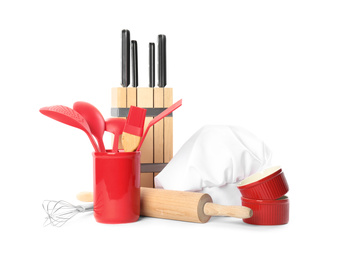 Set of different cooking utensils and chef's hat on white background